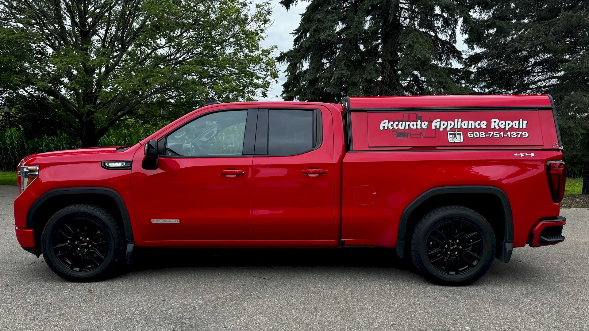 Accurate Appliance Repair red service truck parked in Janesville with contact number on the side